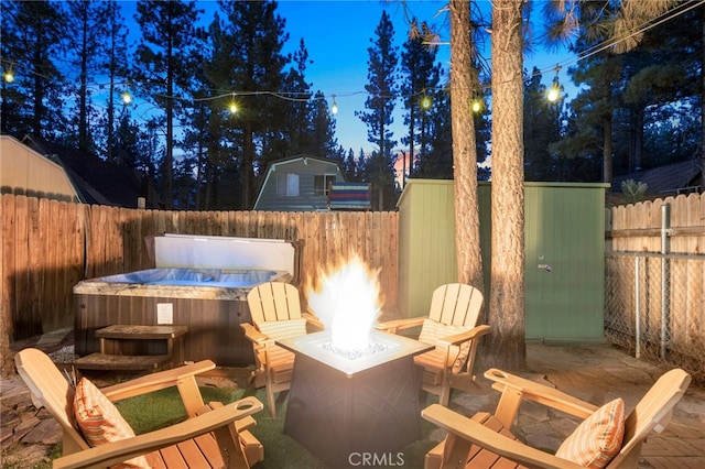 view of patio featuring a hot tub and a fire pit