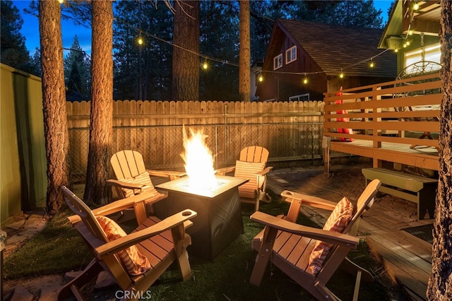 view of patio / terrace featuring a wooden deck and a fire pit