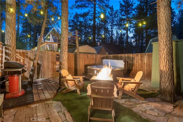 view of patio with a wooden deck, a grill, and a fire pit