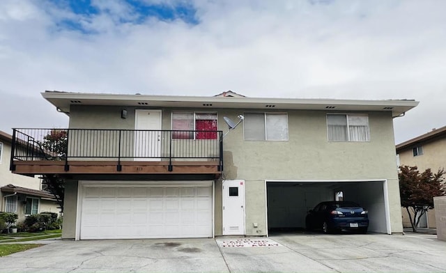 view of front facade featuring a garage and a balcony