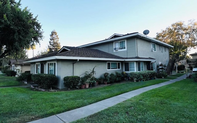 view of property exterior with a lawn