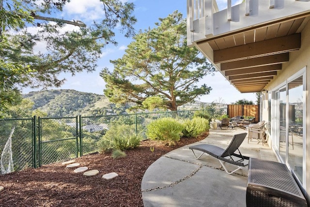 view of yard featuring a mountain view and a patio