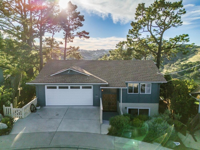 view of front of home with a mountain view and a garage