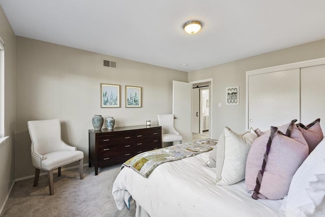 bedroom featuring a closet and light carpet