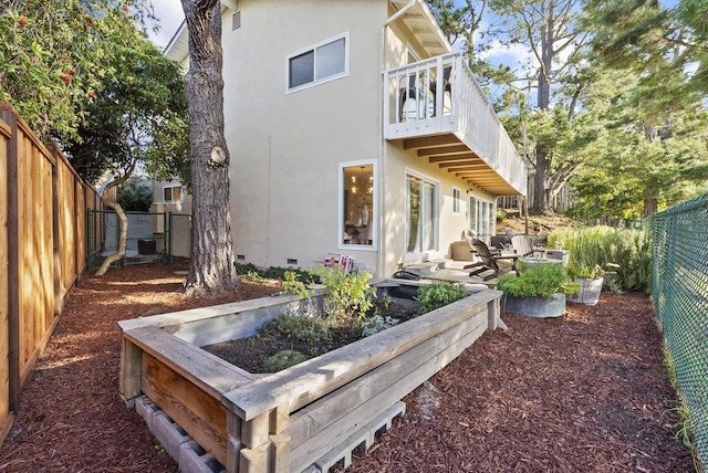 rear view of property featuring a balcony