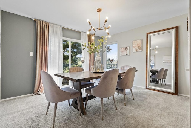 dining room featuring light colored carpet and a chandelier