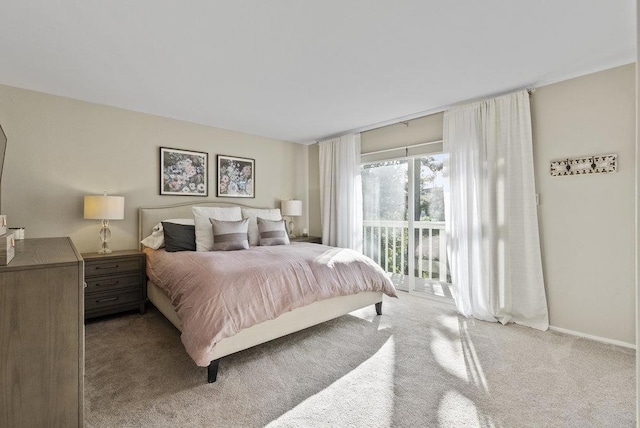 bedroom with light colored carpet and access to exterior