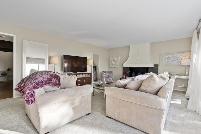 carpeted living room featuring a fireplace