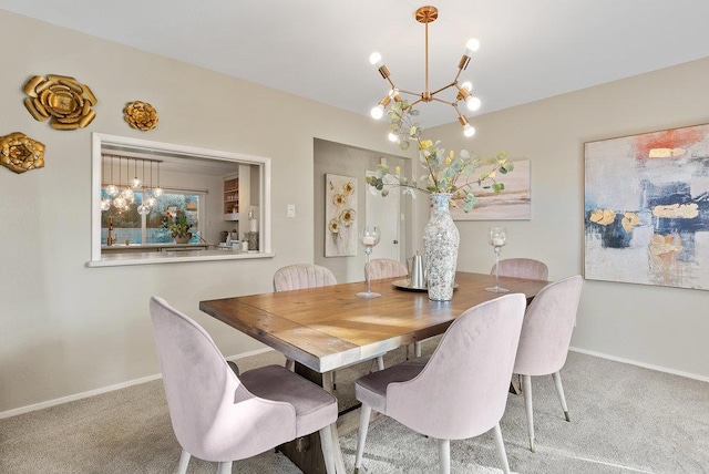 dining space featuring carpet floors and a chandelier