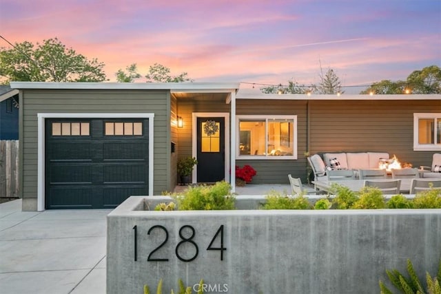 view of front of property featuring an outdoor fire pit and a patio