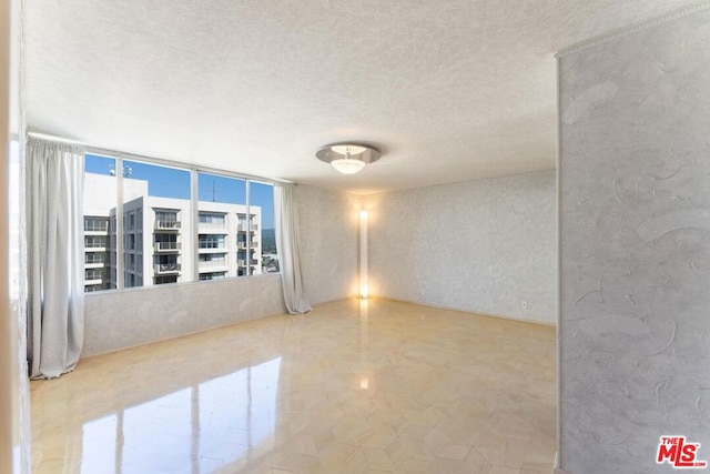 empty room featuring a textured ceiling