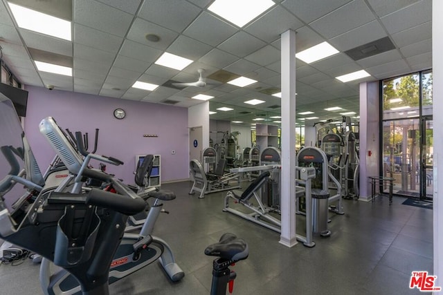 gym with a paneled ceiling