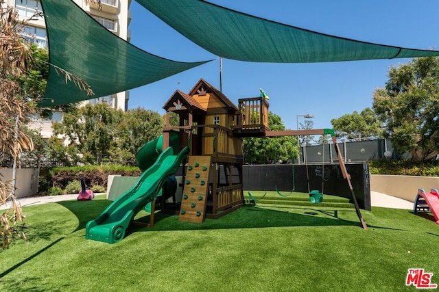 view of playground with a lawn