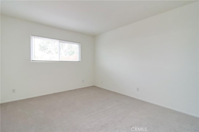 unfurnished room with light colored carpet