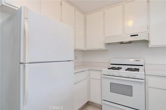 kitchen with white appliances, white cabinets, and light tile patterned flooring