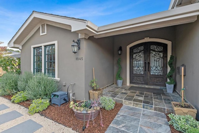 view of exterior entry featuring french doors