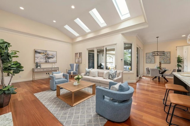 living room featuring crown molding, lofted ceiling, and light hardwood / wood-style flooring