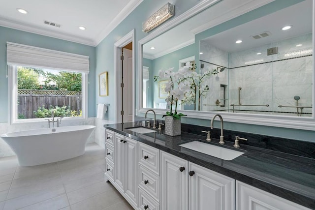 bathroom with tile patterned flooring, crown molding, separate shower and tub, and vanity