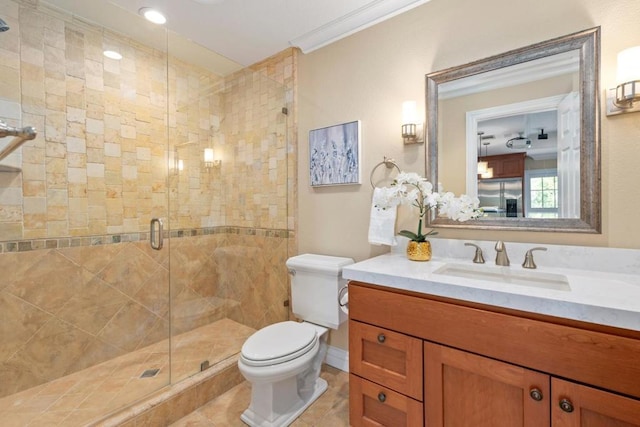 bathroom featuring tile patterned flooring, vanity, ornamental molding, a shower with shower door, and toilet