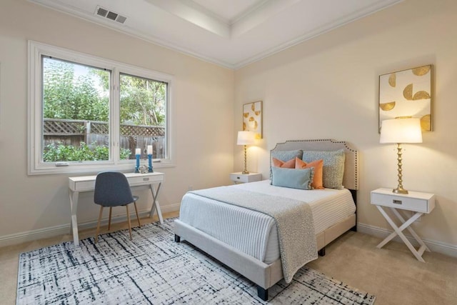 bedroom with crown molding, light colored carpet, and a raised ceiling