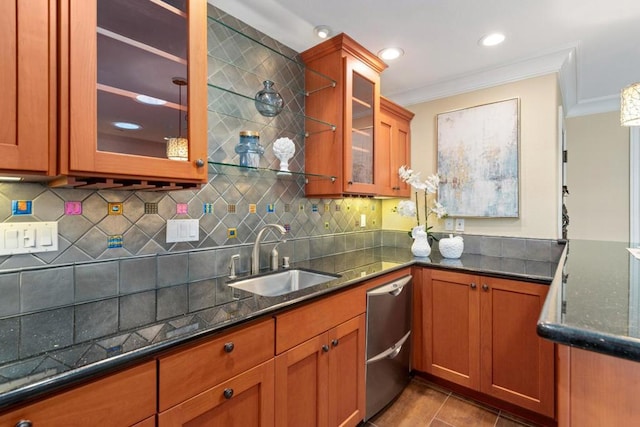 kitchen featuring ornamental molding, sink, and dark stone countertops