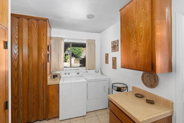 laundry room with light tile patterned floors and washer and dryer