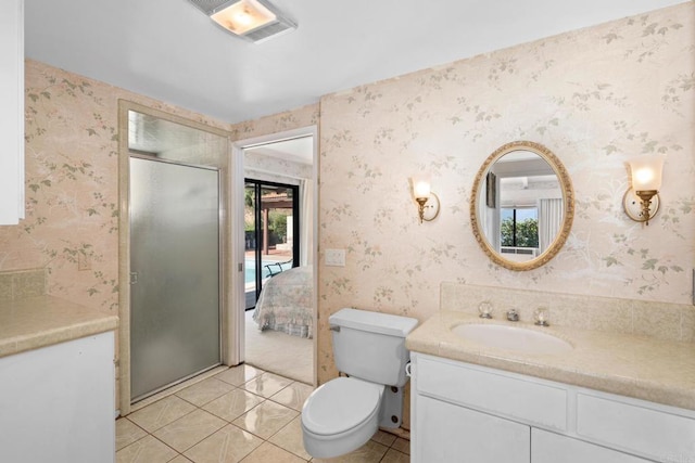 bathroom with an enclosed shower, vanity, tile patterned floors, and toilet