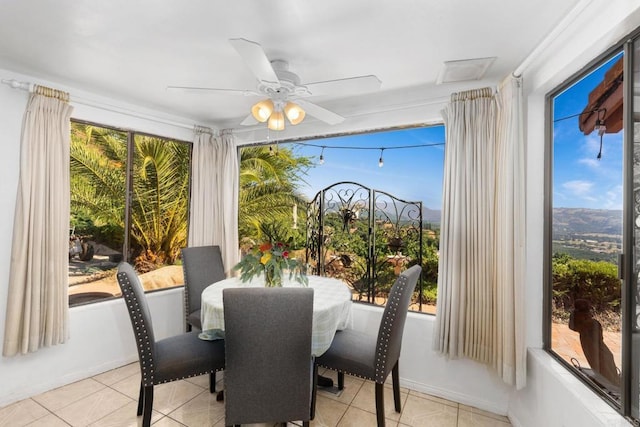 sunroom featuring ceiling fan