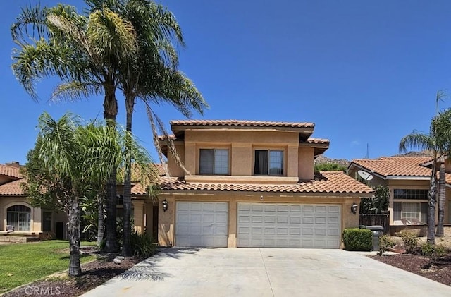 mediterranean / spanish house with a garage