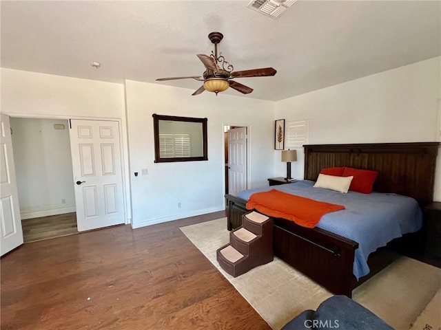 bedroom with dark wood-type flooring and ceiling fan