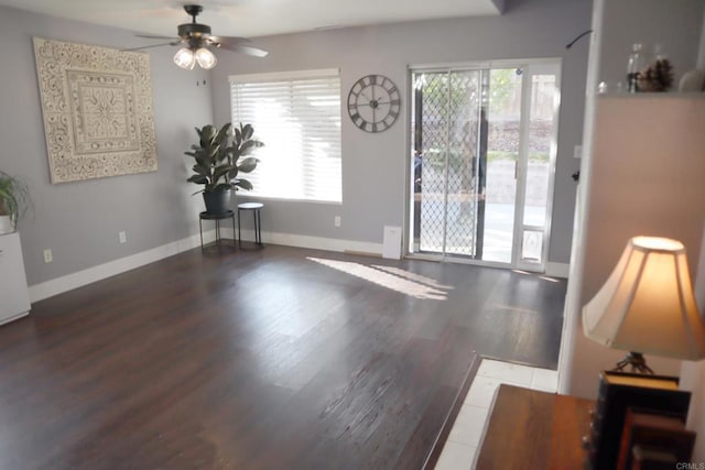 interior space with ceiling fan and dark hardwood / wood-style floors