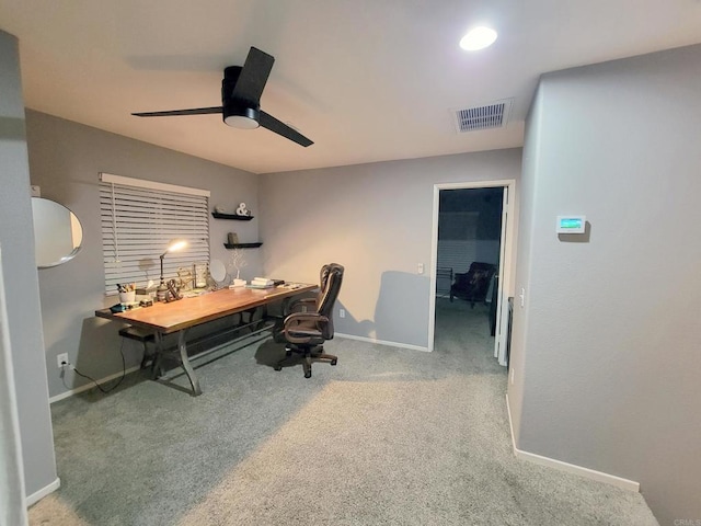 carpeted office featuring ceiling fan