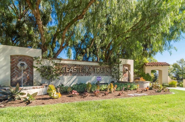 community / neighborhood sign with a lawn