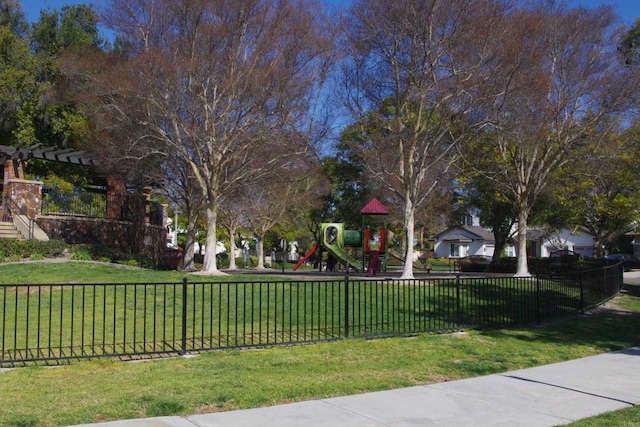 surrounding community featuring a playground and a yard