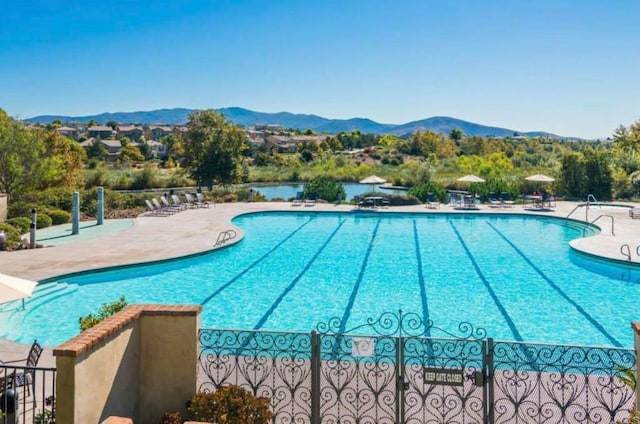 view of swimming pool featuring a mountain view and a patio area