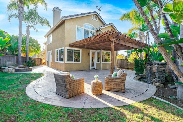 back of property with a pergola, an outdoor hangout area, and a patio