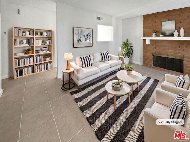 living room with light tile patterned flooring and a fireplace