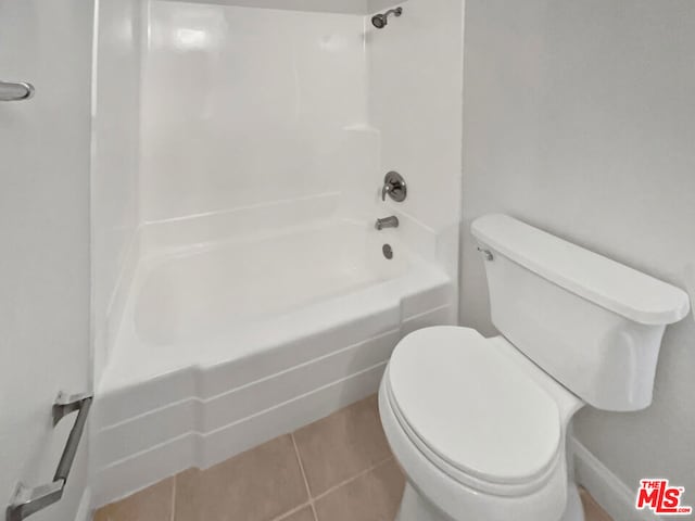 bathroom featuring toilet, tile patterned flooring, and shower / bathing tub combination