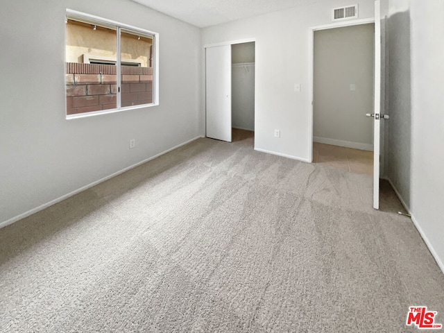 unfurnished bedroom featuring a closet and carpet flooring