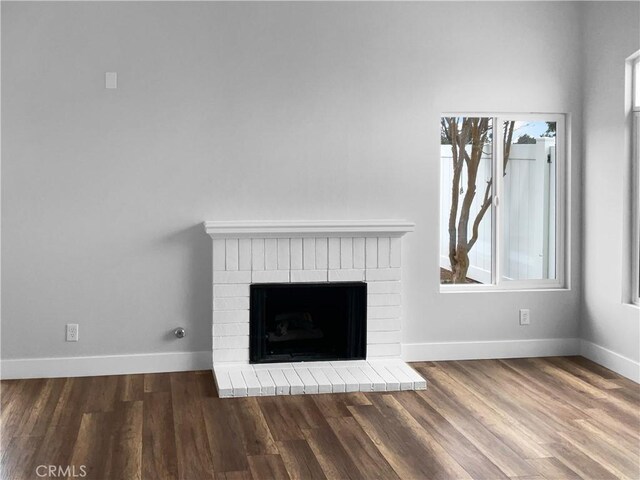 details featuring a brick fireplace and hardwood / wood-style floors