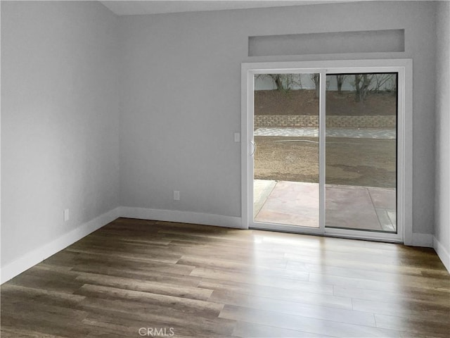 spare room with dark wood-type flooring