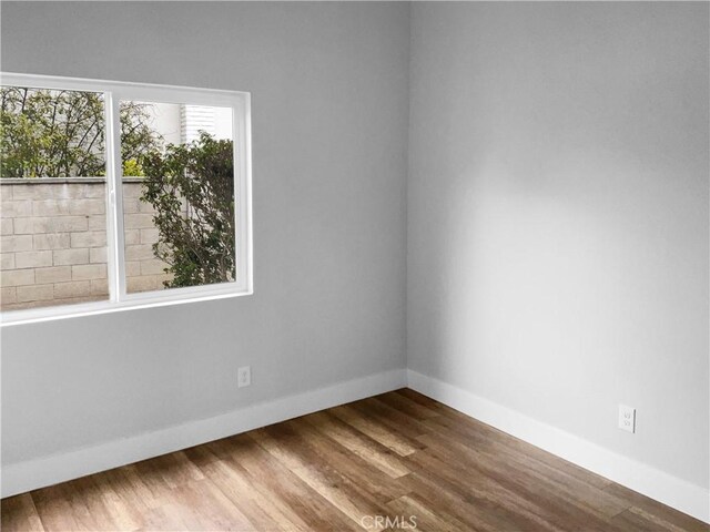 unfurnished room featuring hardwood / wood-style floors