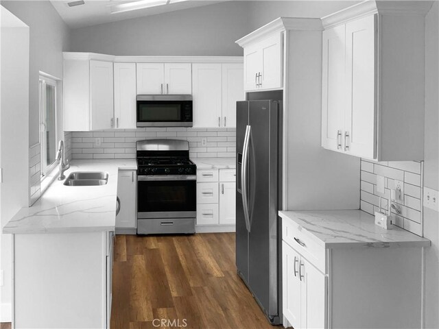 kitchen featuring white cabinetry, appliances with stainless steel finishes, sink, and backsplash