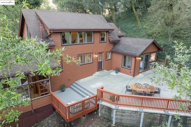 back of house featuring a deck