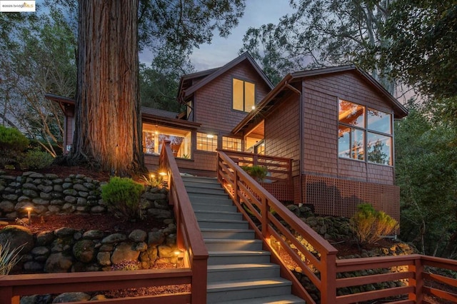 view of back house at dusk