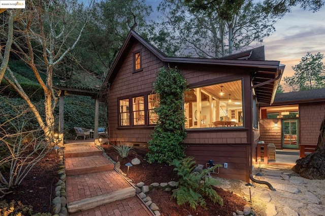 property exterior at dusk with a patio