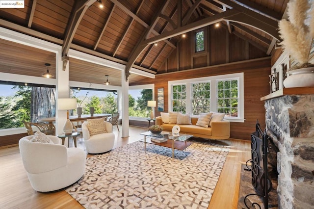 sunroom / solarium featuring lofted ceiling with beams and wooden ceiling