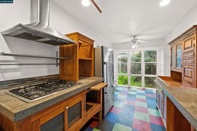 kitchen featuring exhaust hood, ceiling fan, and appliances with stainless steel finishes