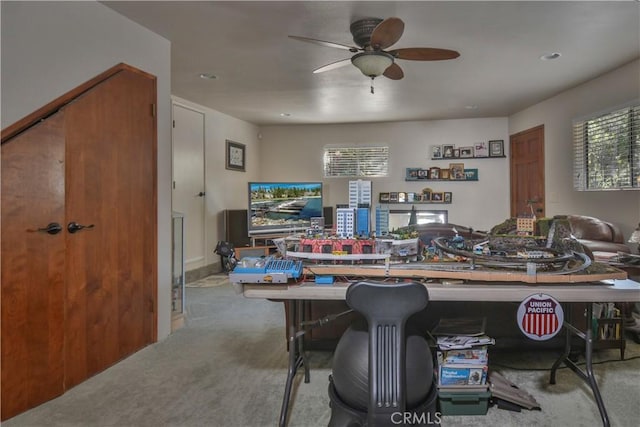 recreation room with ceiling fan and light colored carpet