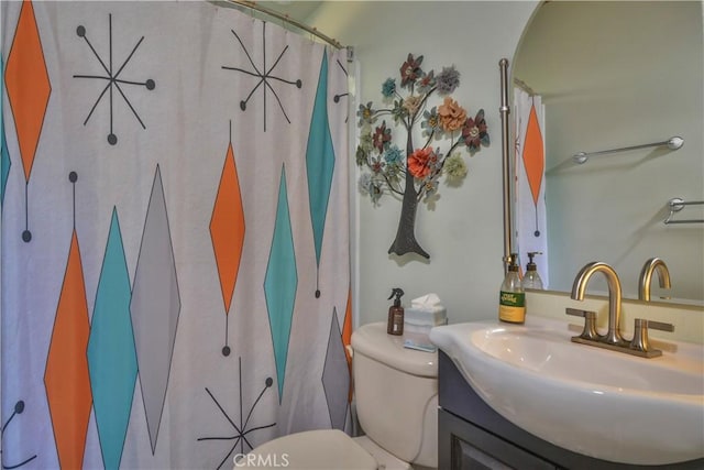 bathroom featuring a shower with curtain, vanity, and toilet